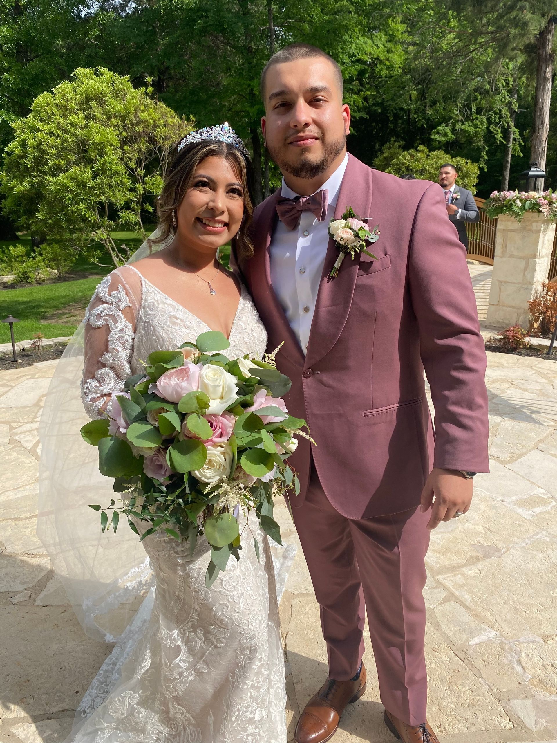 A bride and groom are posing for a picture on their wedding day.