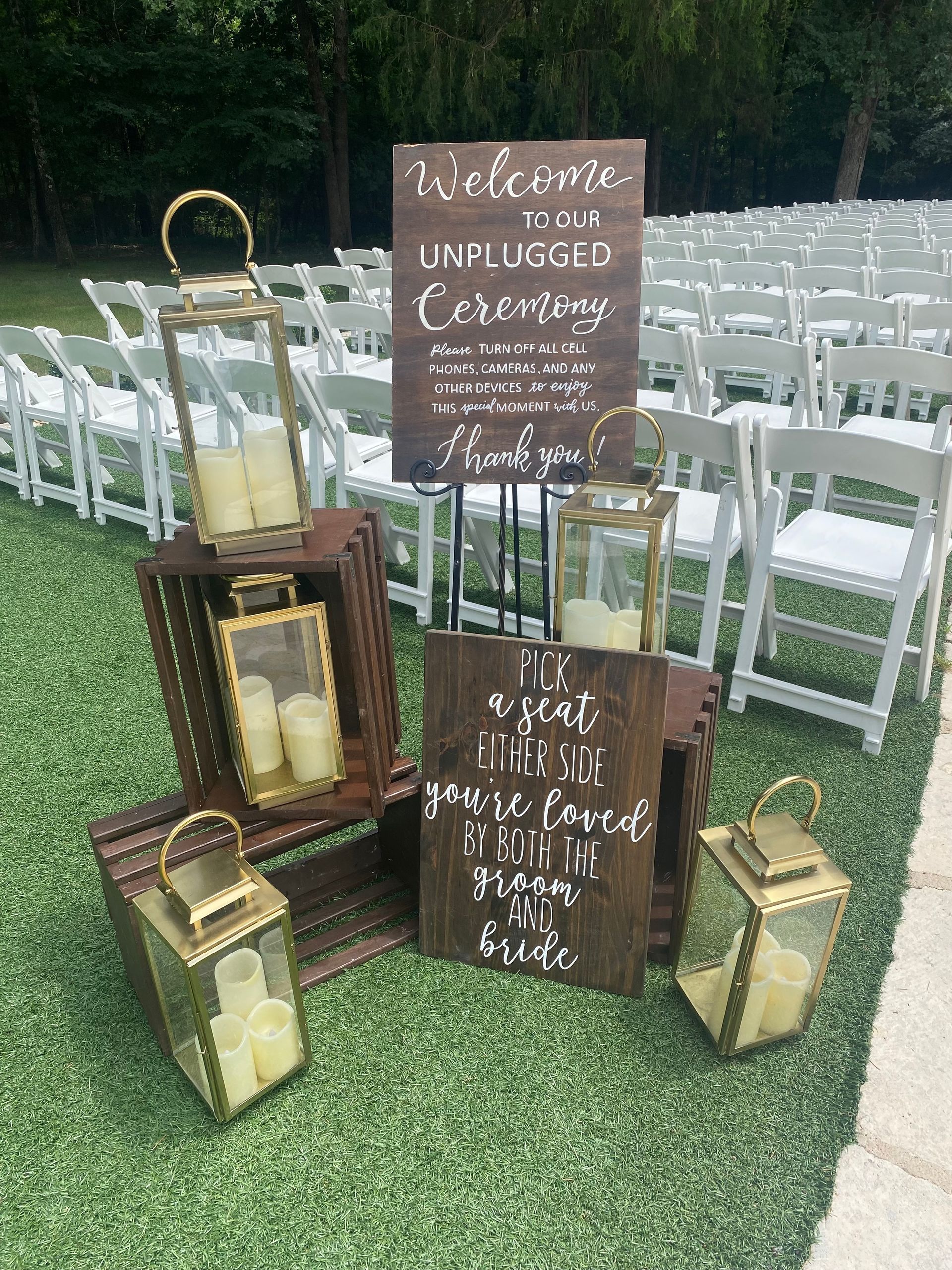 A wooden sign is sitting on top of a row of chairs.