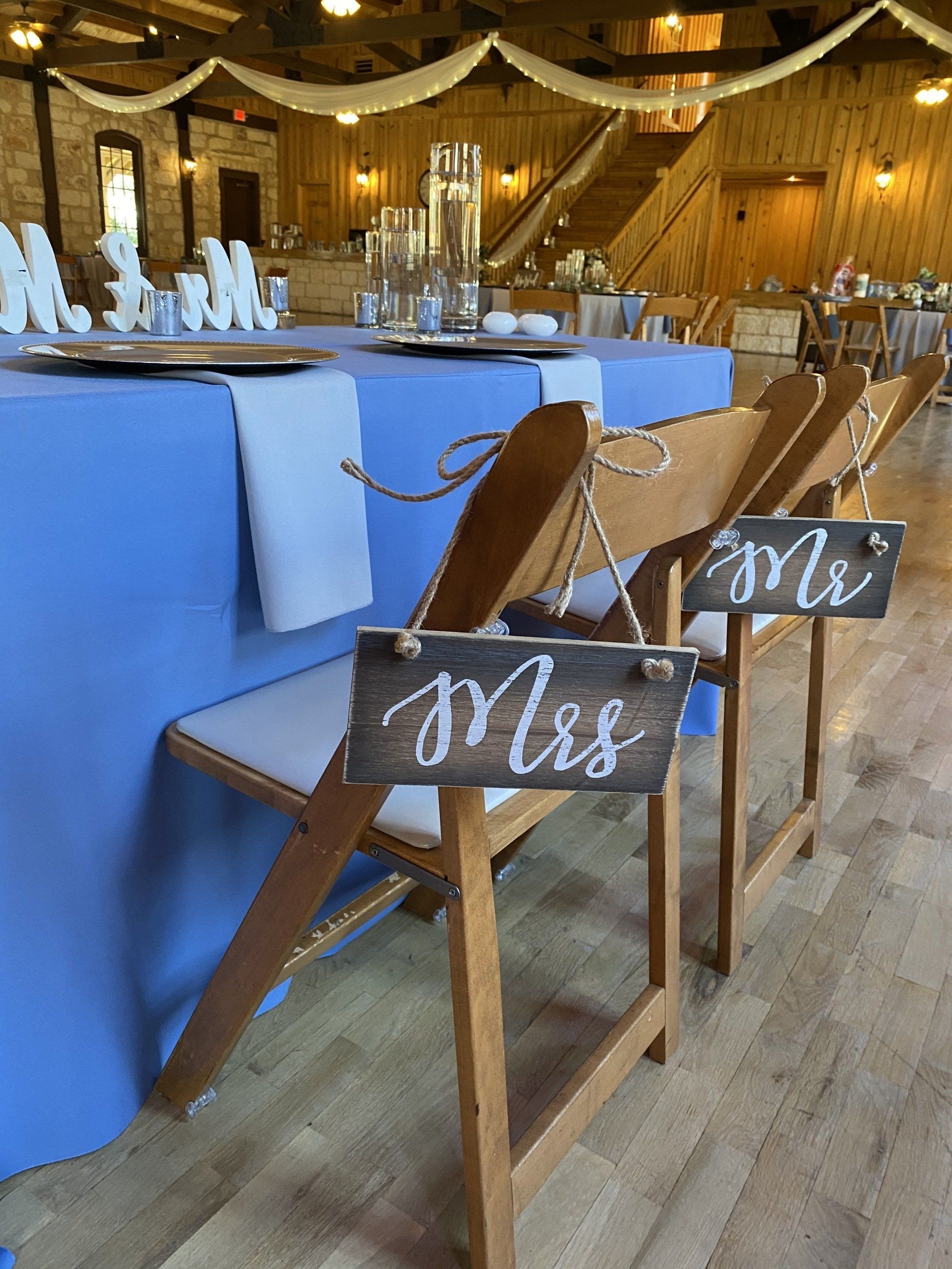 A couple of chairs with signs on them that say mrs. and mr.