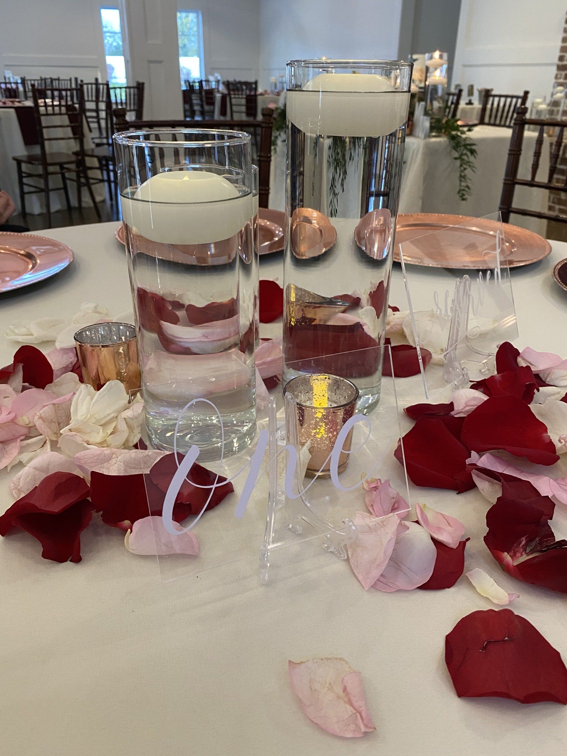 A table with candles and rose petals on it