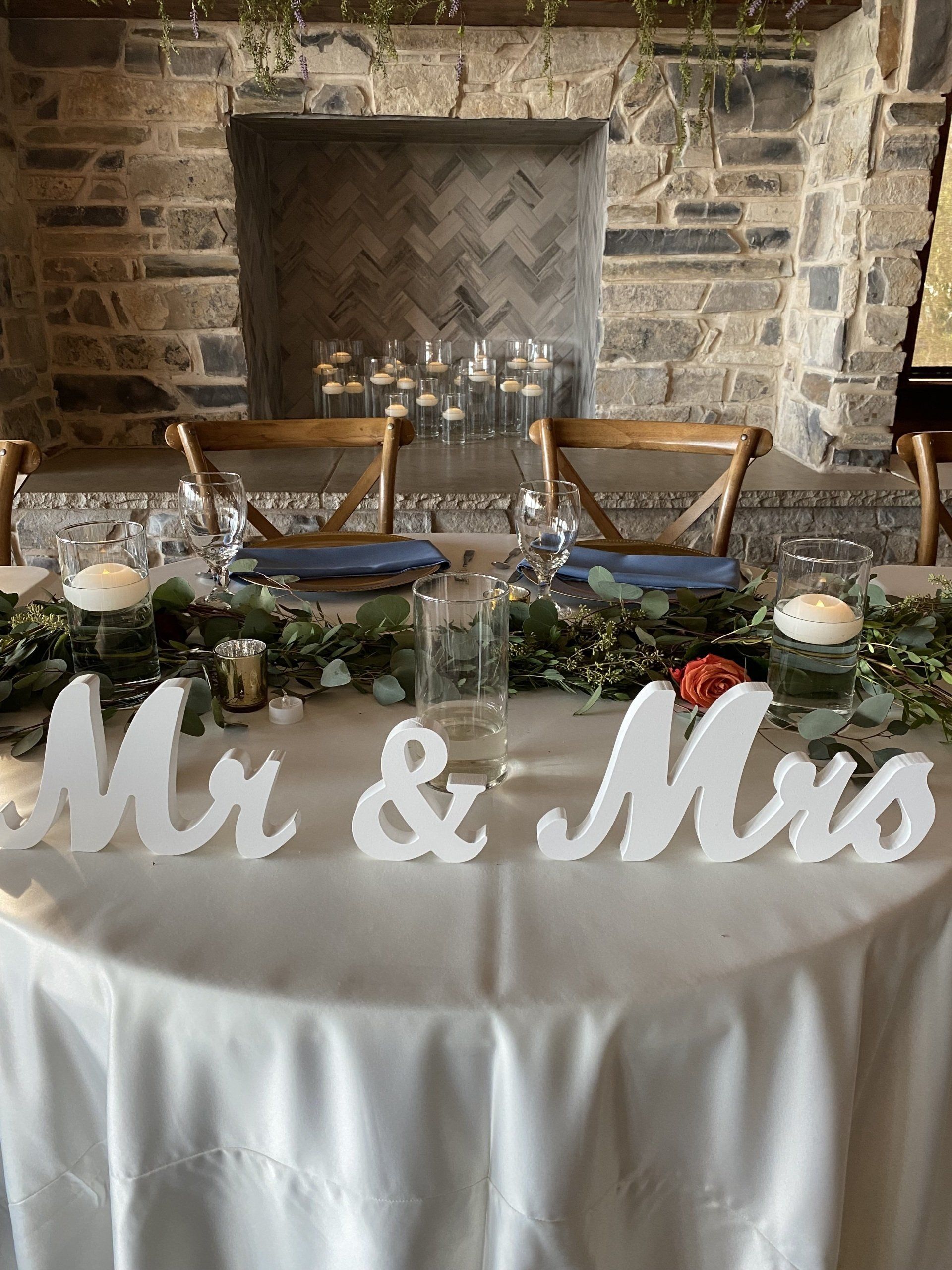 A table with a sign that says mr. and mrs. on it.