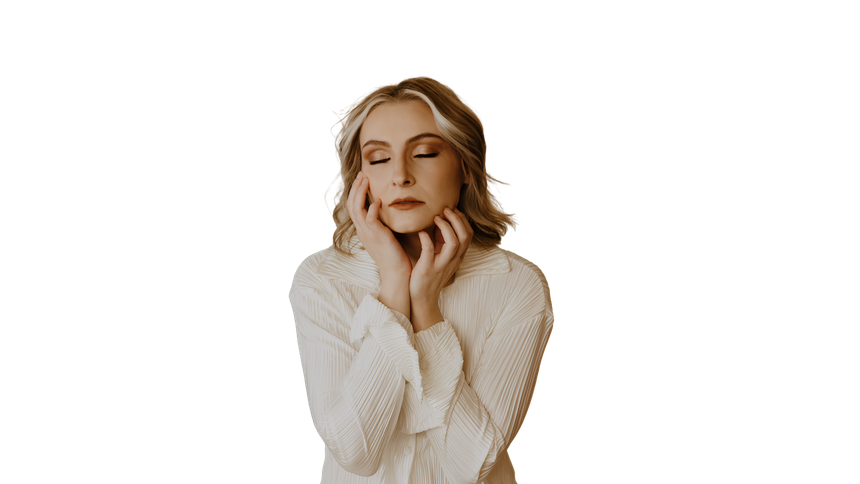 Woman in a white sweater with closed eyes and hands resting on her neck against a white background