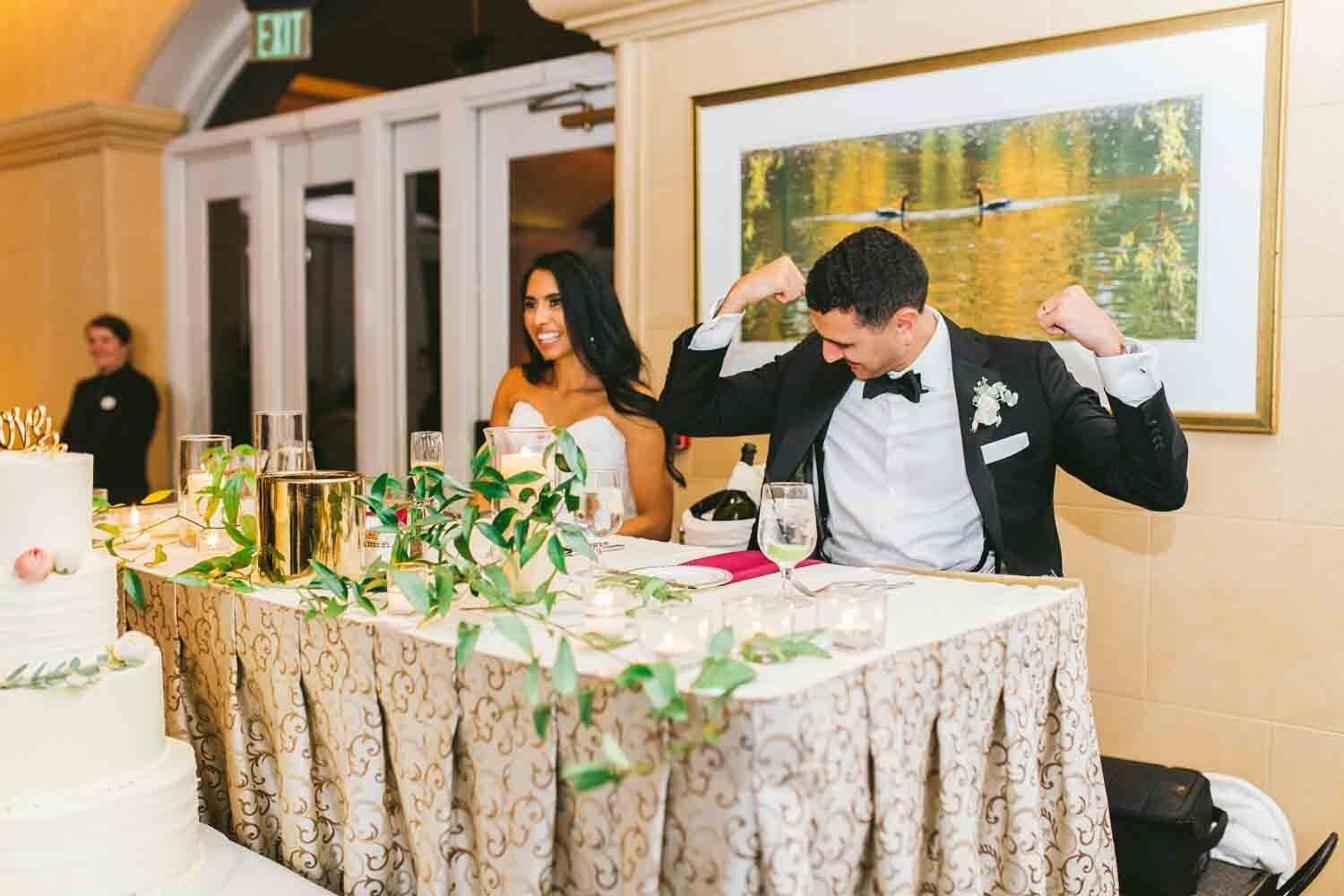 beautiful newlywed couple smiling at wedding reception