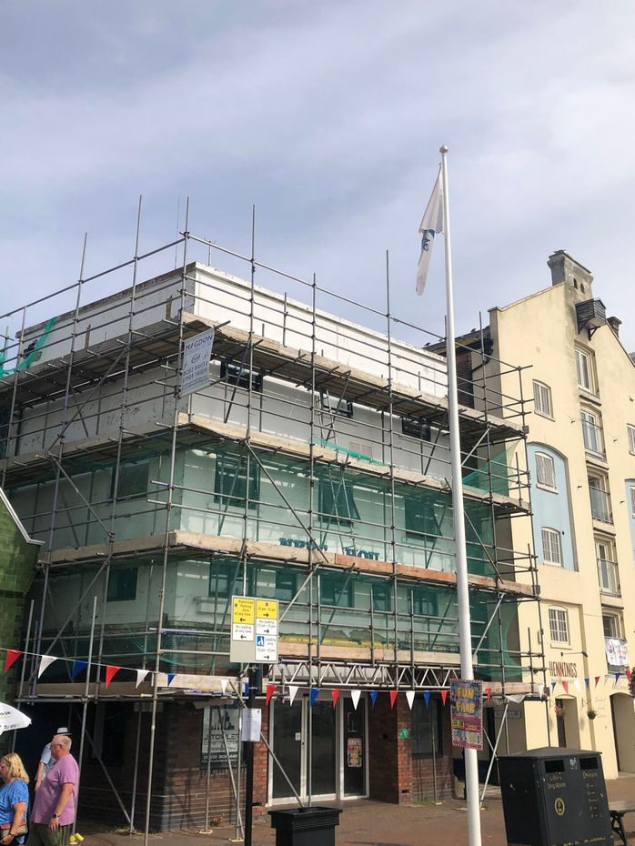 This is a photo of a Commercial building in Leicester with a scaffolding tower up. this was done by Leicester Scaffolding Services JK