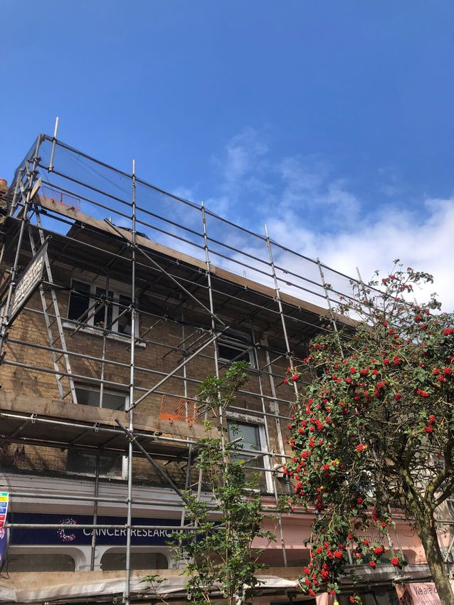 This is a photo of some flats with a scaffolding tower up. this was done by Leicester Scaffolding Services JK