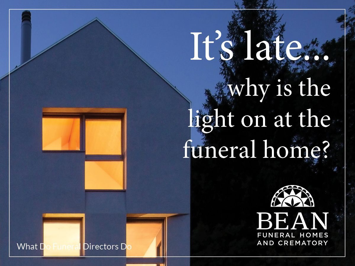Funeral home building at night with lights on.