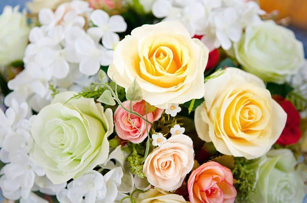 Floral arrangement with white, yellow, and pink roses