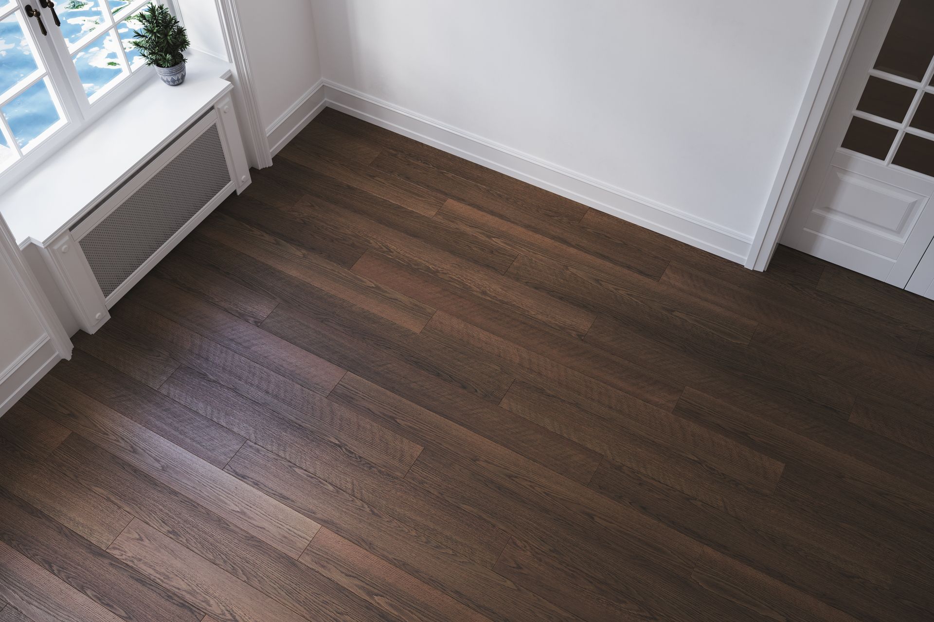 Dark wood floor in a mostly empty room with a window, white walls, and a door. Dark wood floor in a mostly empty room with a window, white walls, and a door.