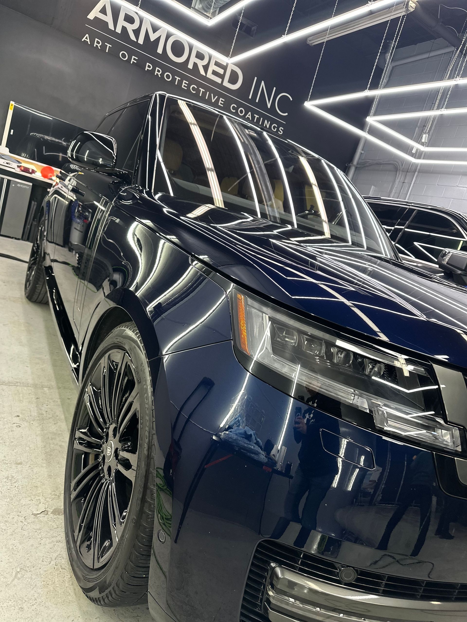 A dark blue Land Rover parked inside a garage with 