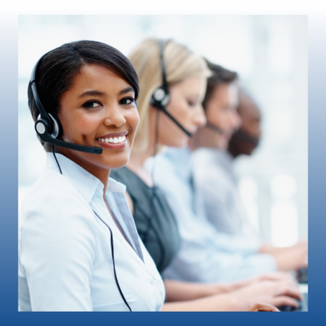 Call center team wearing headsets, with a smiling agent in the foreground