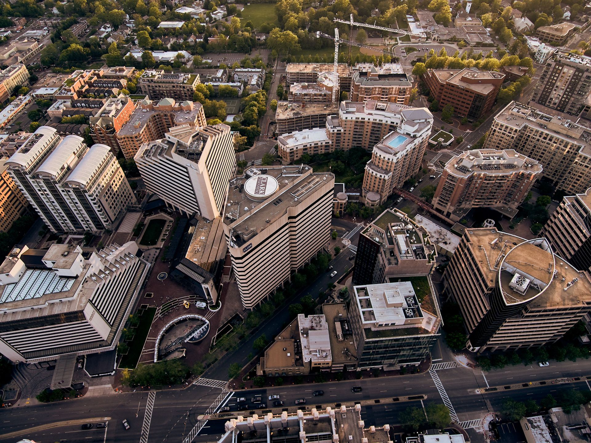 Aerial view of a dense city center with tall buildings, streets, and a large road intersection