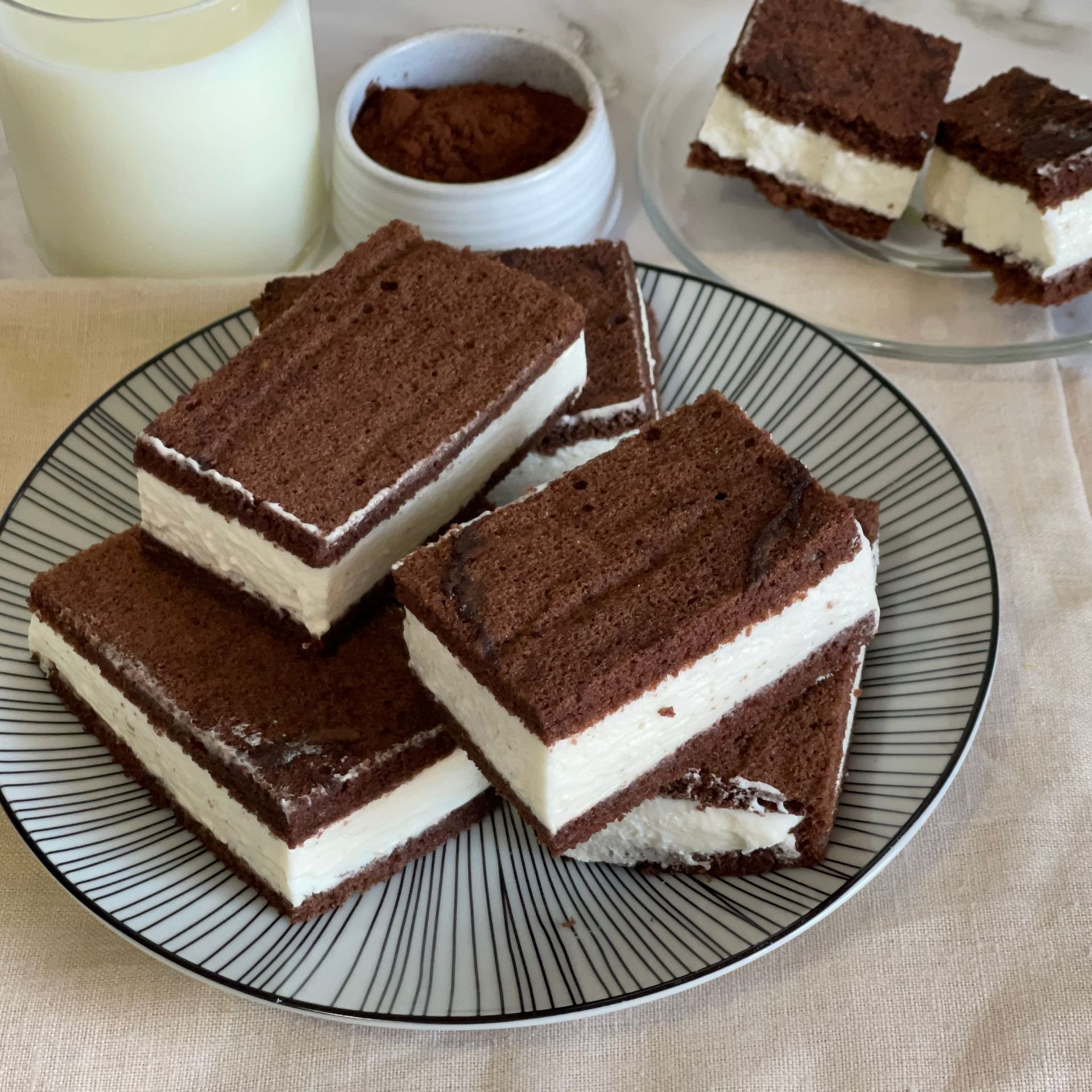 Un piatto di sandwich al gelato al cioccolato accanto a un bicchiere di latte