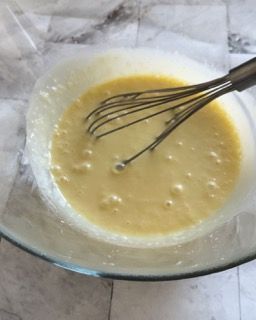 Una ciotola di liquido con una frusta dentro