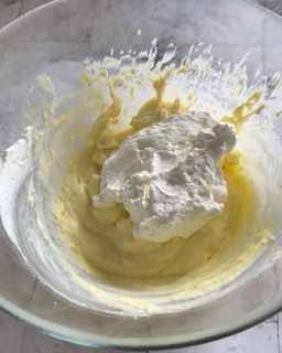 Primo piano di una ciotola di panna montata su un tavolo.