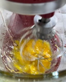 Un mixer sta mescolando le uova in una ciotola di vetro
