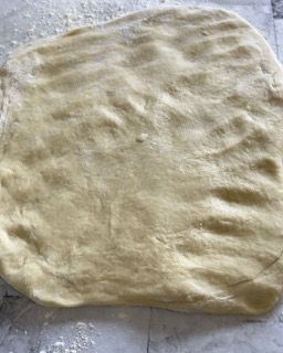 Un pezzo di pasta è appoggiato su un tavolo.
