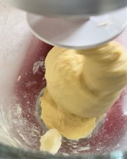 Un mixer sta mescolando una sostanza gialla in una ciotola di vetro.