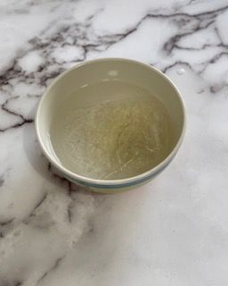 Una ciotola d'acqua è appoggiata su un tavolo di marmo.