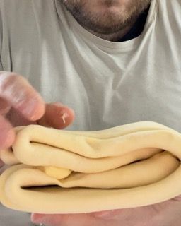 Un uomo tiene in mano un pezzo di pasta