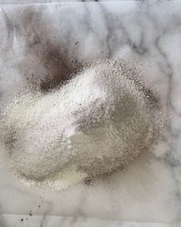 Un mucchio di farina è appoggiato su una superficie di marmo.