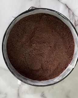 Una teglia piena di cioccolato in polvere è appoggiata su un tavolo.