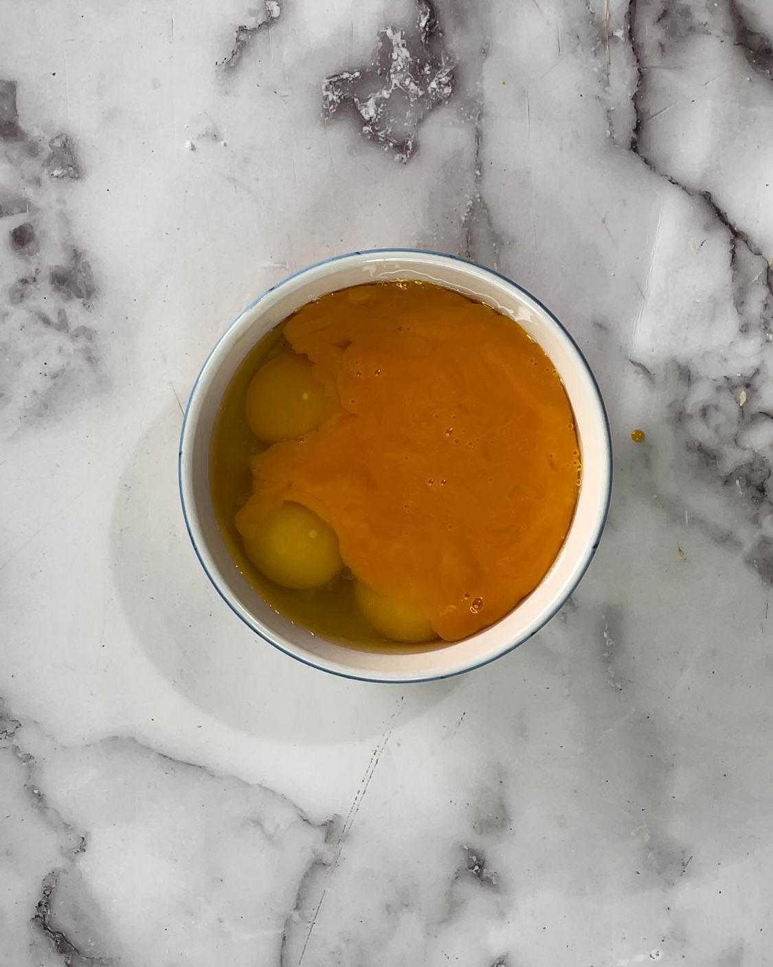 Una ciotola di zuppa è appoggiata su una superficie di marmo.