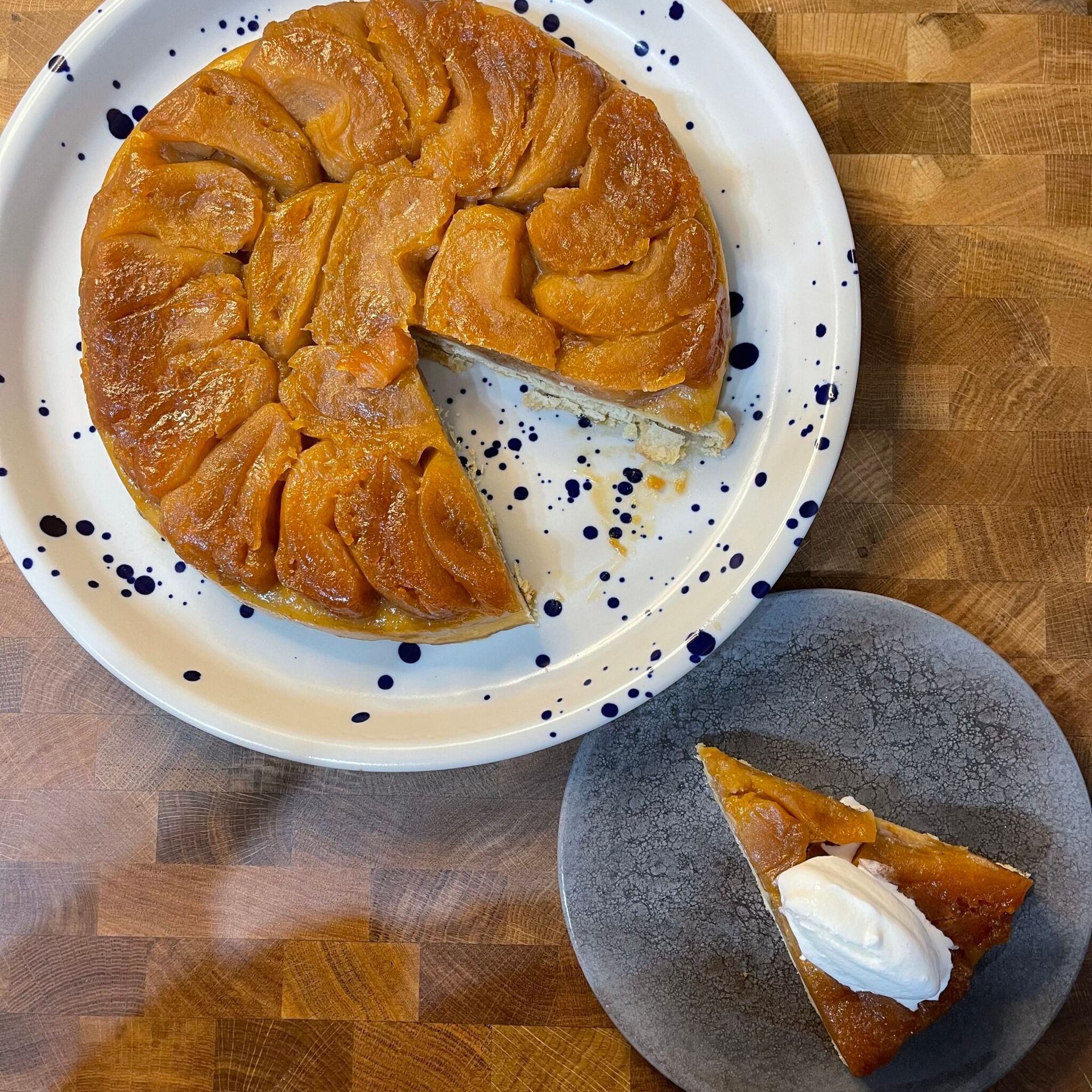 Una torta da cui è stata staccata una fetta si trova su un piatto accanto a una fetta di torta.