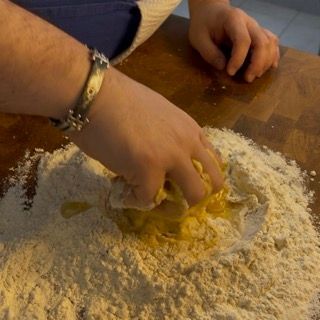 Lavorazione della pasta per i galani veneziani fino a ottenere un composto grezzo.
