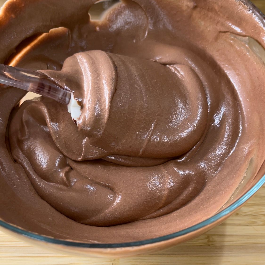 Una ciotola di budino al cioccolato con un cucchiaio dentro