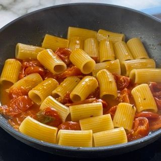 Una padella piena di pasta e pomodori