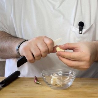 spicchi d'aglio interi, su un tagliere.