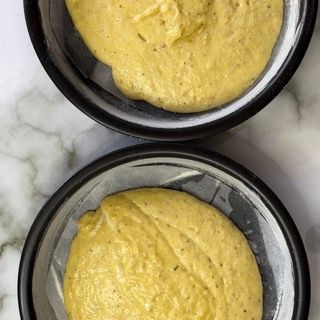 Due ciotole di salsa gialla sono appoggiate su un tavolo.