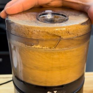 Una persona tiene in mano il coperchio di un robot da cucina