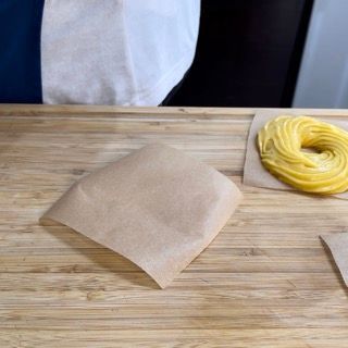 Preparazione dei quadrati di carta forno 12x12 cm per la formatura della zeppola di san giuseppe.