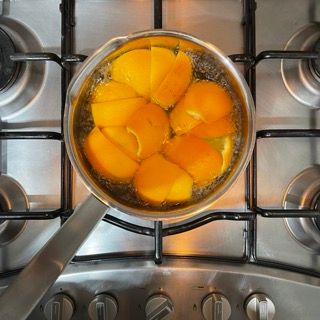 Una pentola di pesche sta cuocendo sul fornello