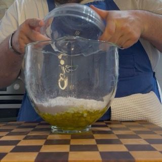 Grattugiatura della scorza di limoni freschi della Costiera per aromatizzare la torta caprese bianca.