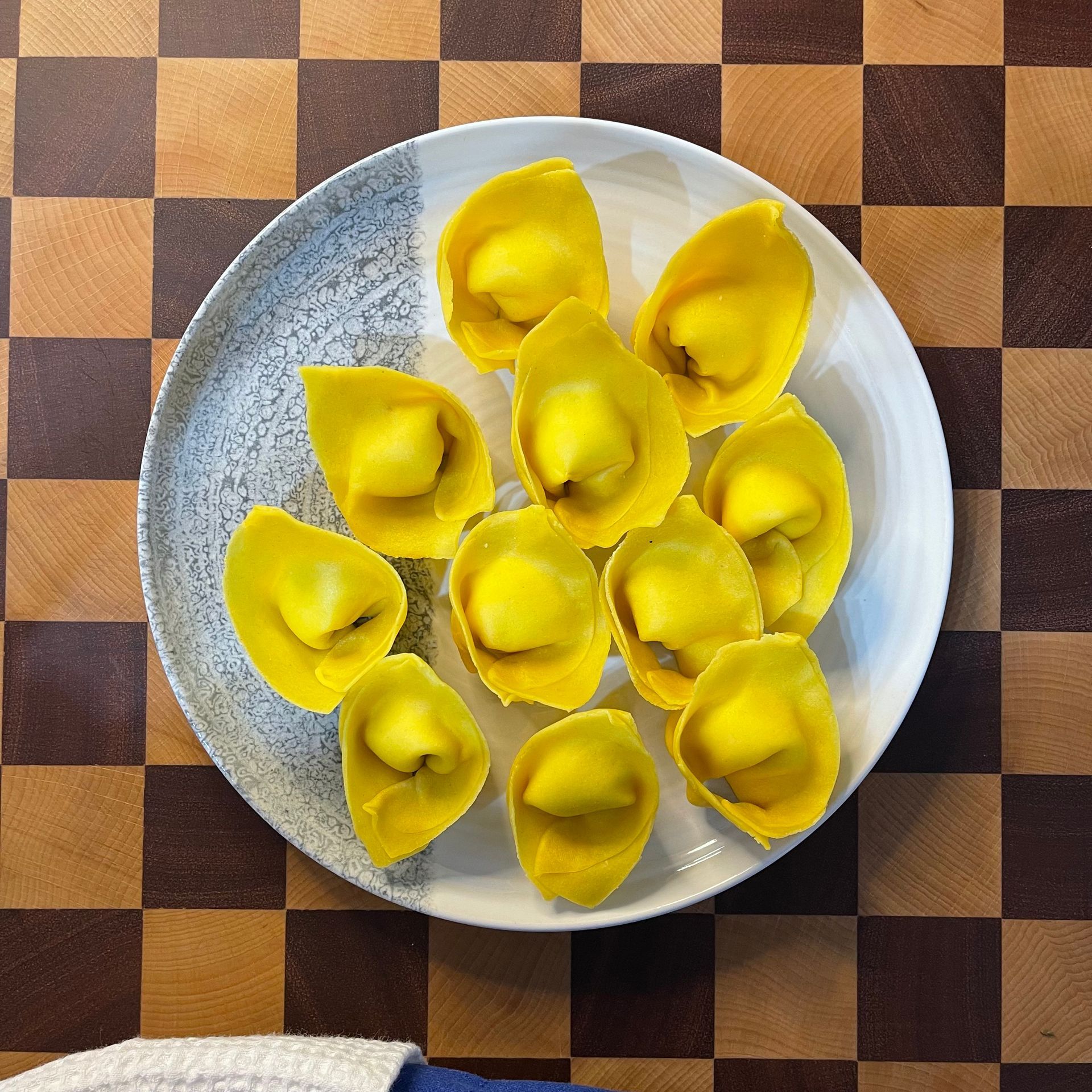 Un piatto di tortelloni fatti con impasto oro,  pasta fresca all'uovo con tuorli 