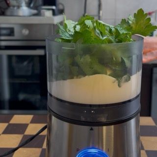 Aggiunta di un pizzico di sale sopra il mix di yogurt, maionese ed erbe fresche.