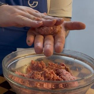 Leggera pressione manuale per schiacciare la pallina e modellarla in un disco spesso e regolare.