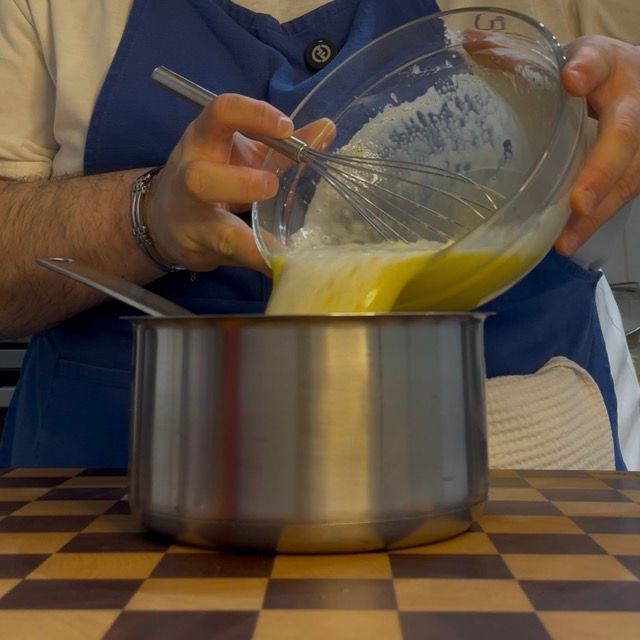 Crema che si addensa nel pentolino sul fuoco.