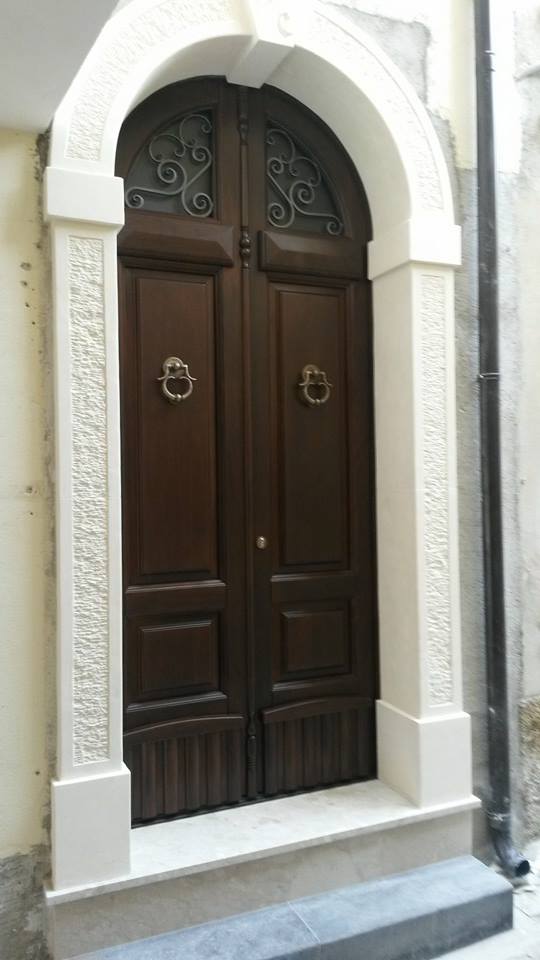 arched wooden door with white stone jamb