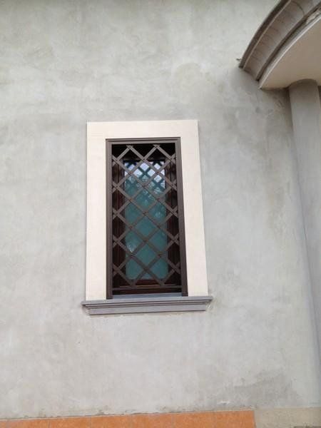 window with grille and white stone frame