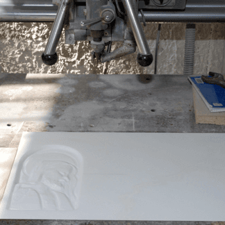 white marble slab with religious frieze