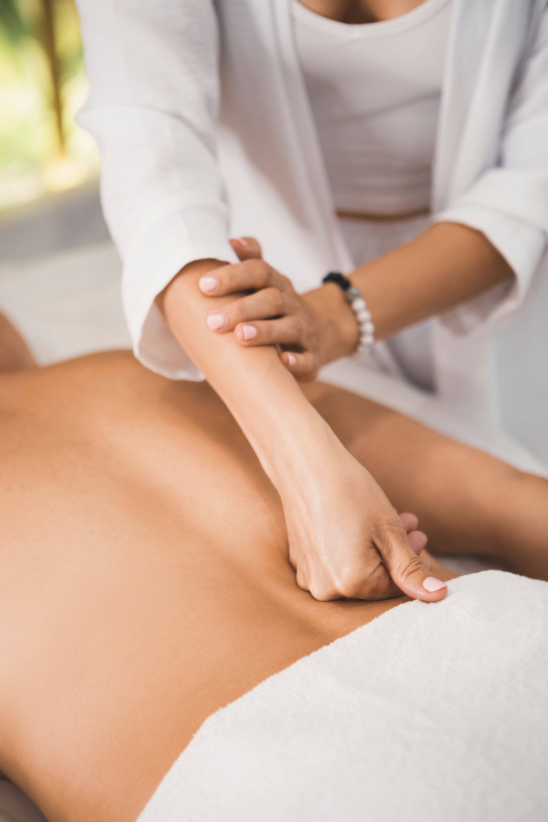 A woman is giving a man a massage in a spa.