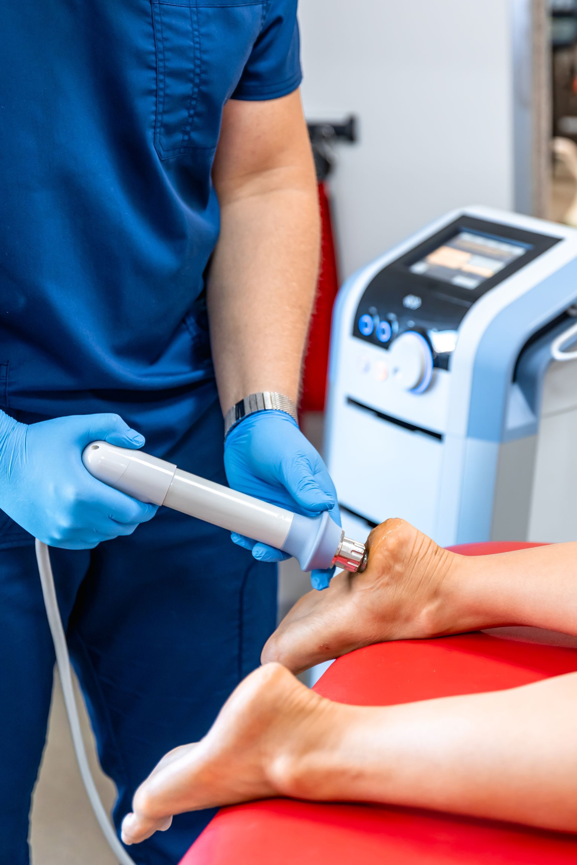 A doctor is using a machine on a patient 's foot in Guelph, ON