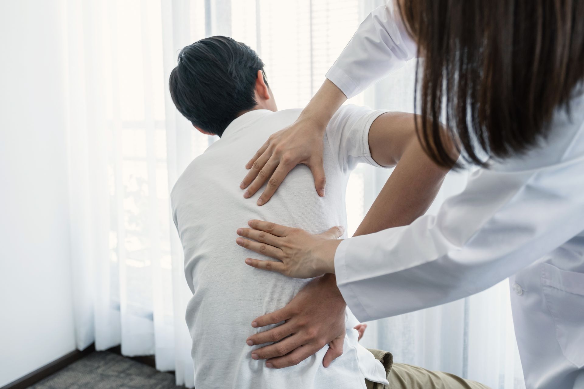 A man is getting a massage from a female doctor in Guelph, ON