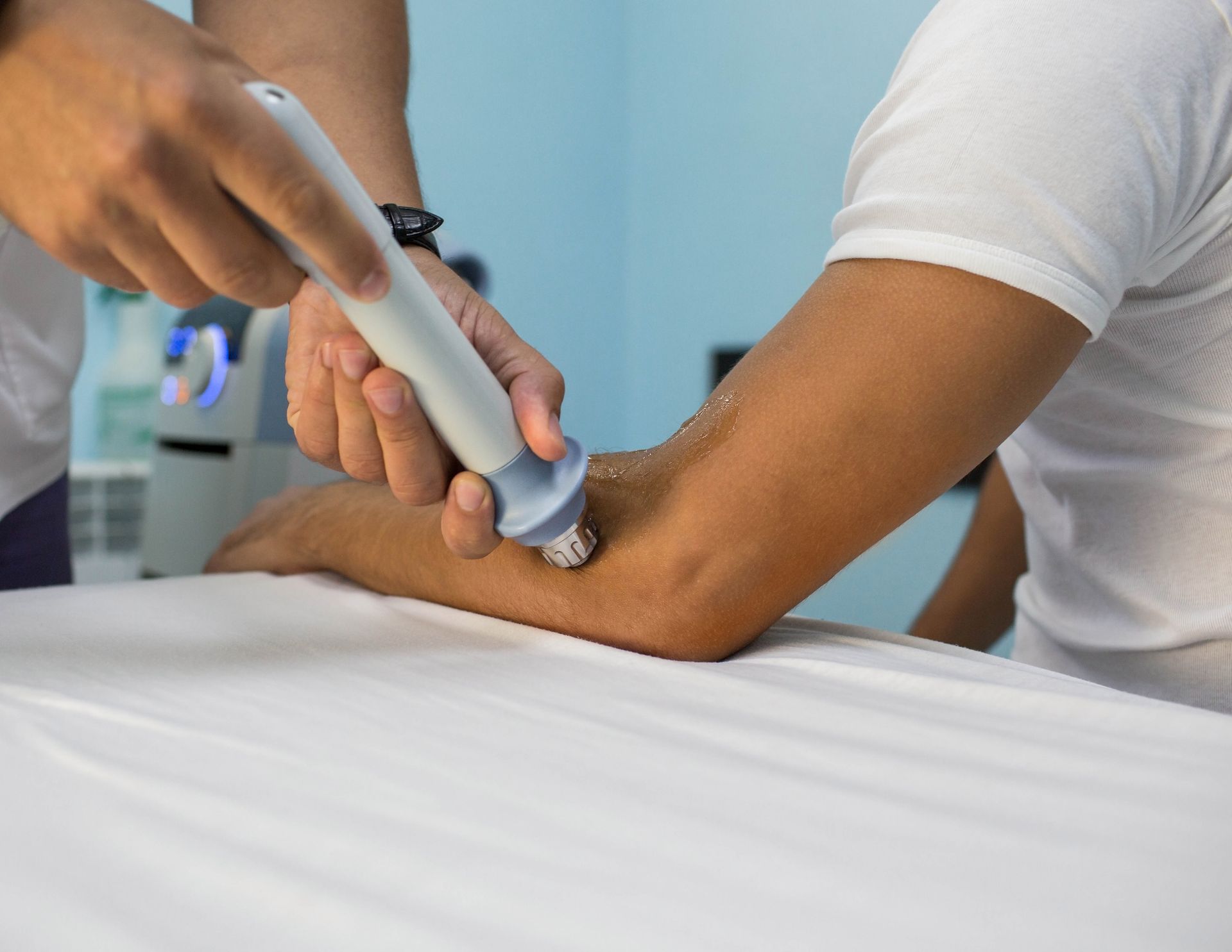 A person is getting an ultrasonic treatment on their elbow.