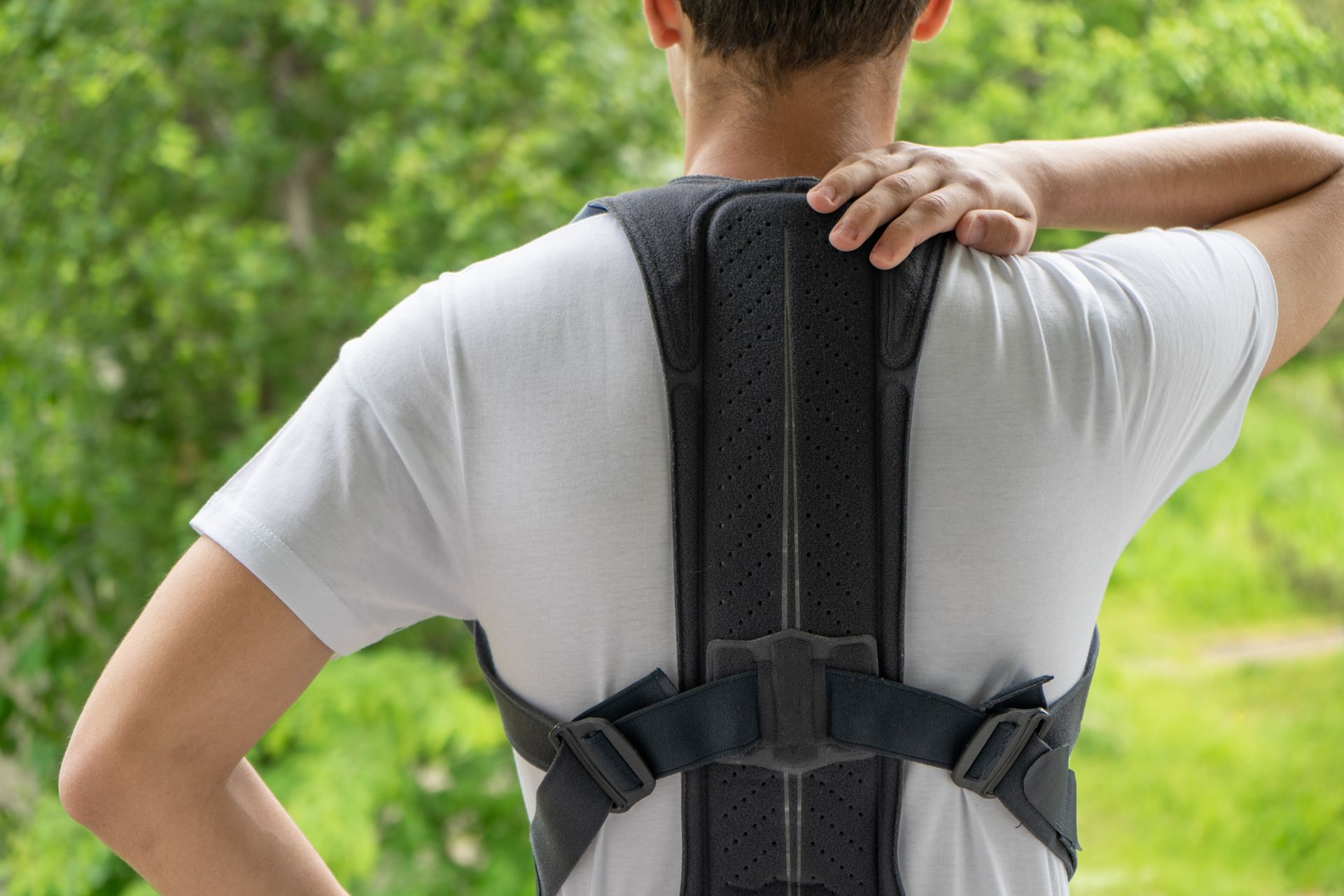 A man is wearing a posture corrector on his back in Guelph, ON