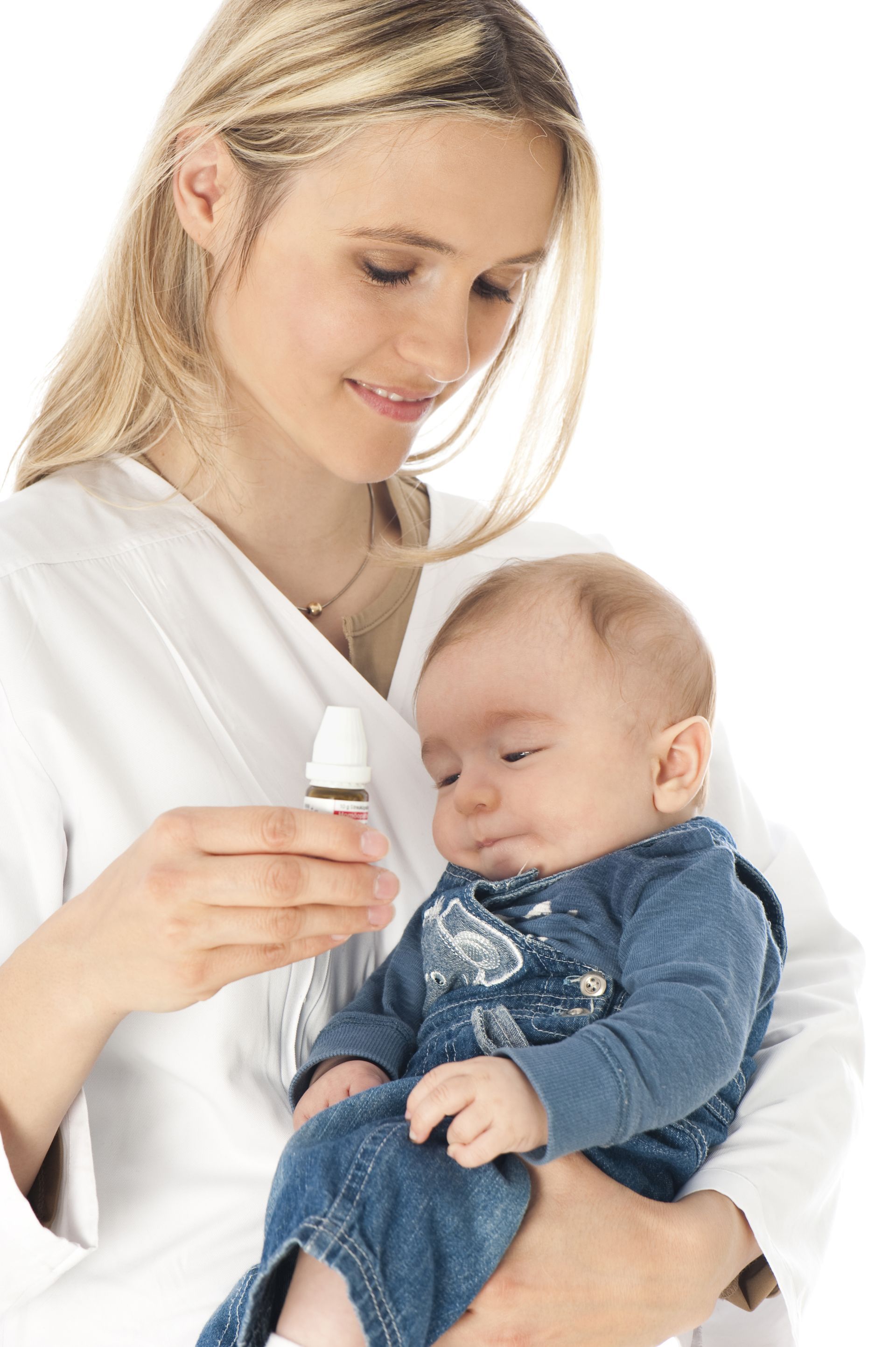 A woman is holding a baby and holding a bottle