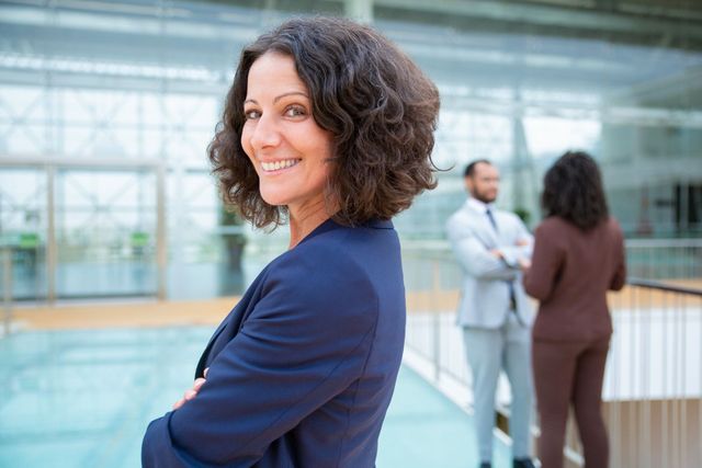 A woman is standing in front of a group of people in an office.